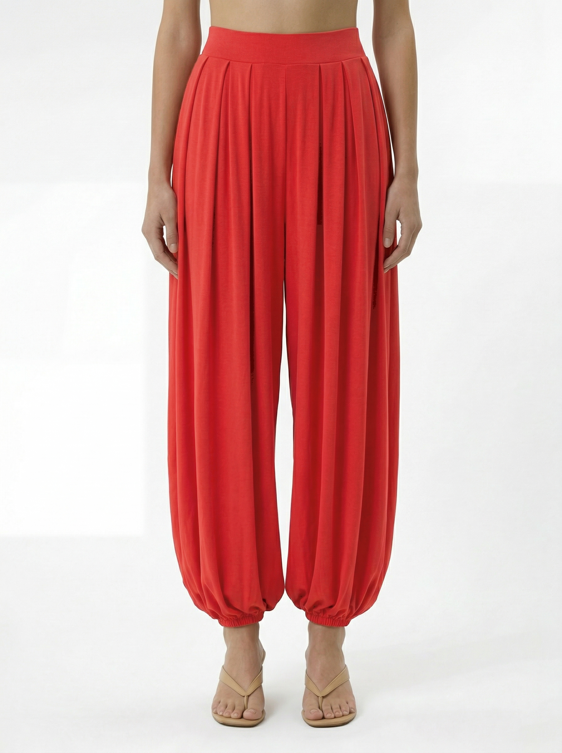 Red modal draped pants with pleated front and elastic waistband detail