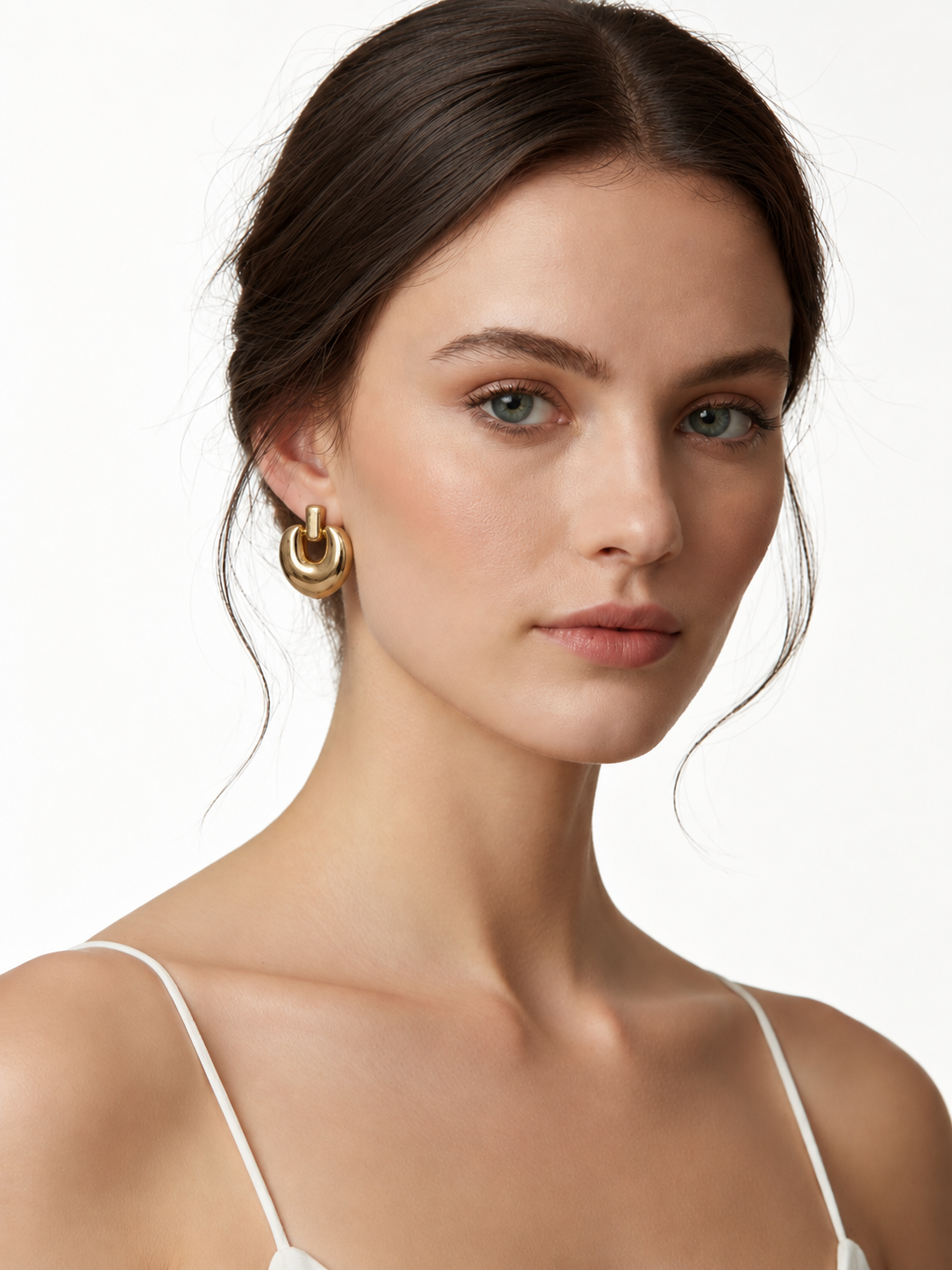 Ellipse Form Gold Earrings On A Modal