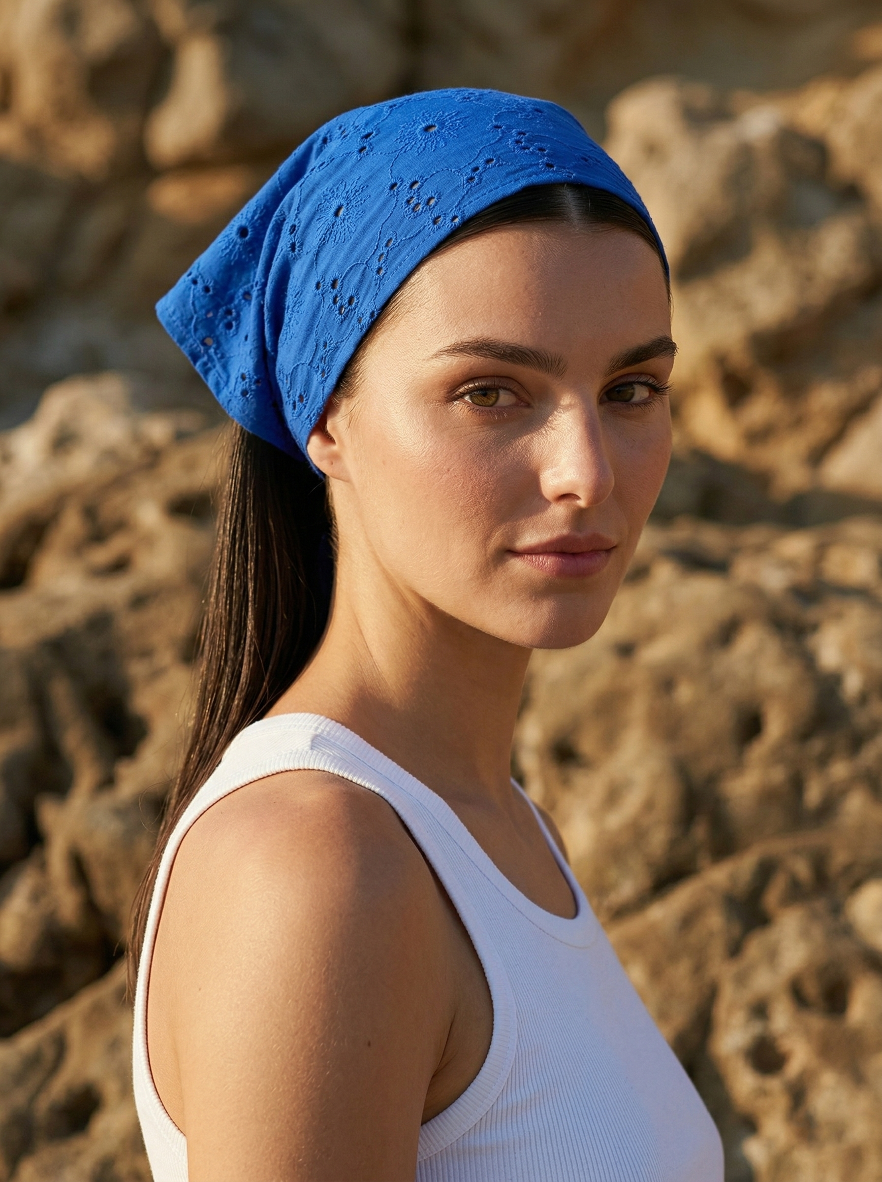 Blue broderie anglaise cotton bandana styled on model in natural sunlight