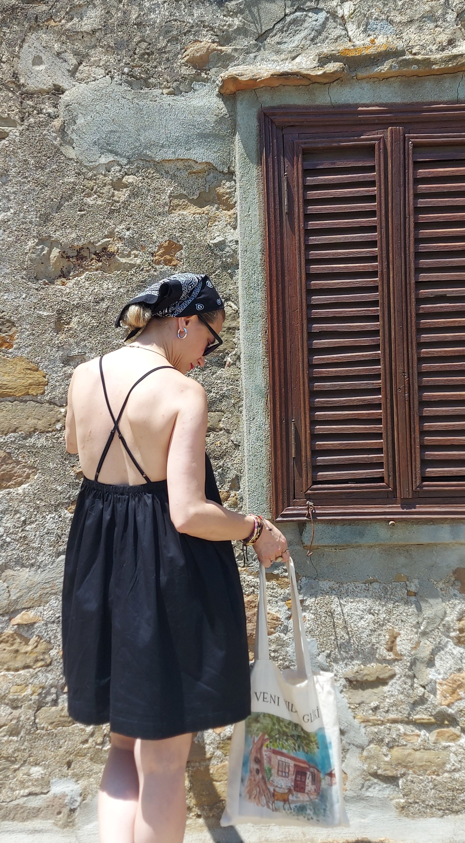 Daisy black cotton satin dress combining simplicity and modern femininity
