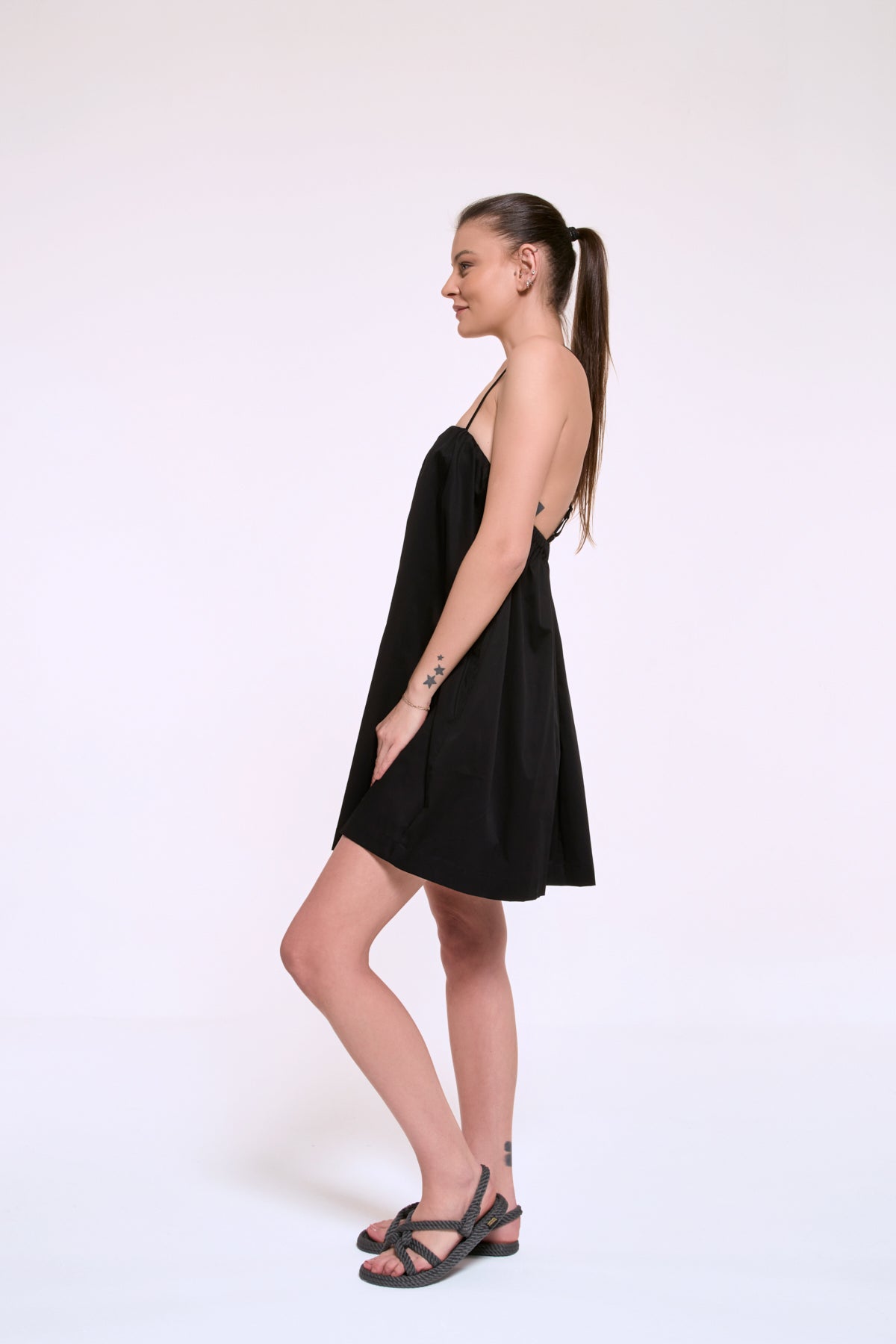 Daisy black mini dress side view with relaxed silhouette