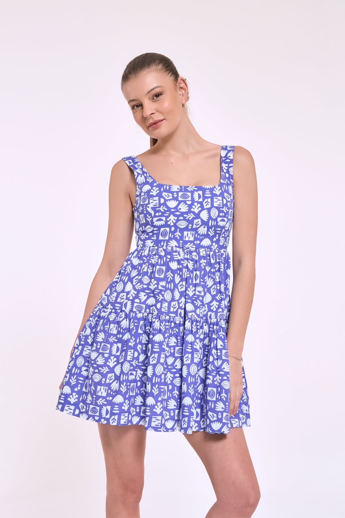 Diana blue mini dress featuring a custom island-inspired pattern designed by the brand