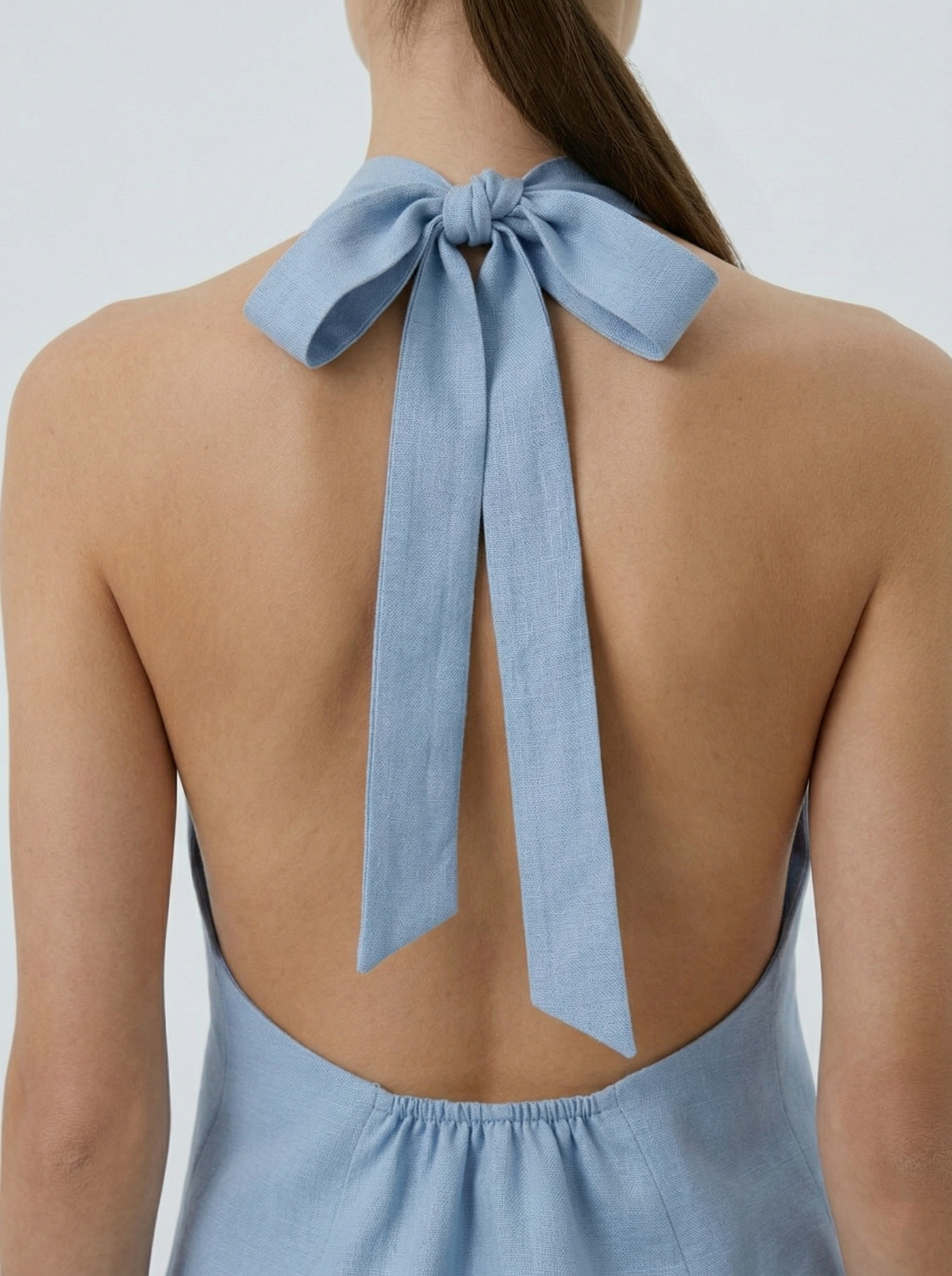 Sally ice blue backless vest back view bow tie detail halter neck